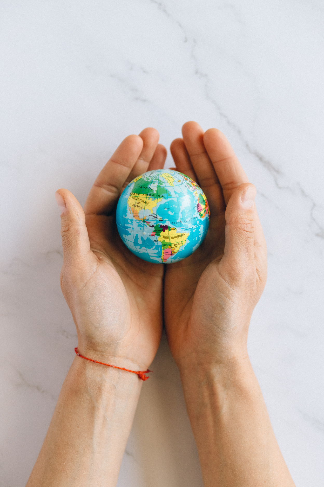 Person Holding a Globe 